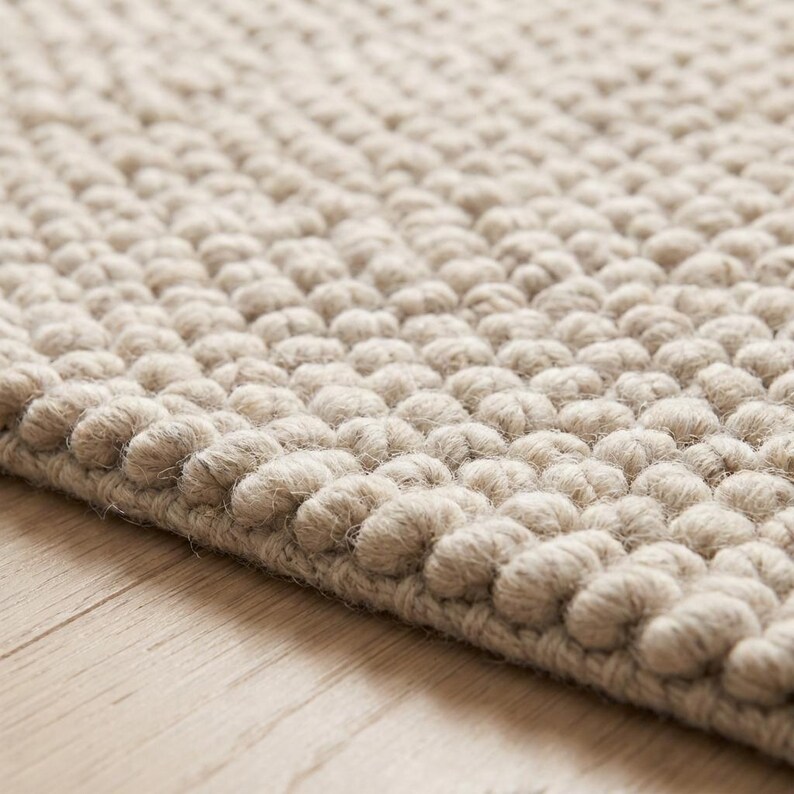 Edge detail of chunky loop rug showing dense braided yarn construction