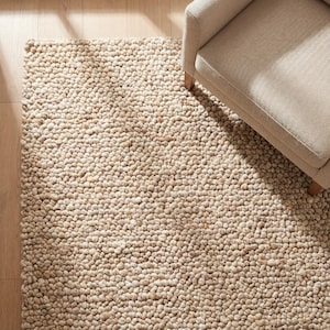Grof wollen vloerkleed beige handgeweven tapijt met kiezelsteentextuur neutraal minimalistisch woonkamer kinderkamer zacht dik vloerkleed