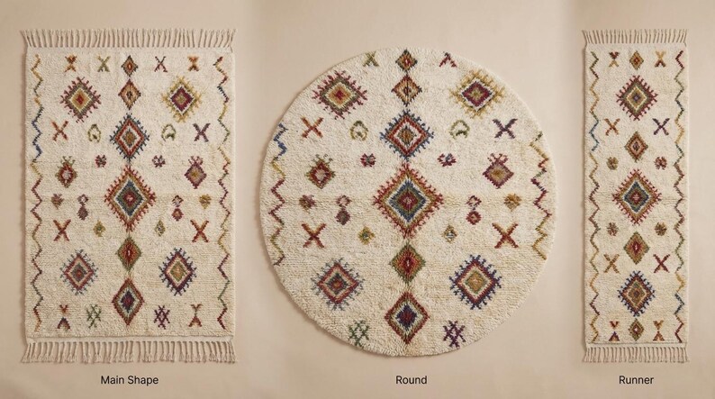 May include: Three ivory-colored rugs with geometric patterns. The rugs are rectangular, round, and runner-shaped. Each rug features diamond and cross designs in shades of red, blue, green, and brown. The rectangular and runner rugs have fringed edges.