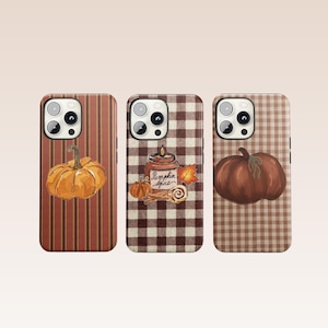 May include: Three smartphone cases featuring autumn designs. The left case has vertical stripes and a pumpkin. The centre case has a brown and white gingham pattern with a candle labelled Pumpkin Spice, a small pumpkin, and cinnamon sticks. The right case has a brown gingham pattern and a large pumpkin.