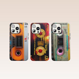 May include: Three phone cases with retro cassette tape designs. The cases feature vibrant colors, including orange, red, and yellow, with details like tape reels and labels. One case has the word "MEMORIES" printed on it.
