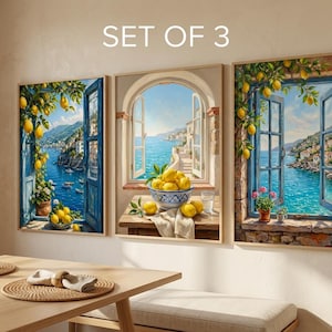 May include: Set of three framed art prints depicting open windows overlooking a coastal Italian town. Each print features a vibrant blue sea, lemons, and architectural details. The text "SET OF 3" is at the top.