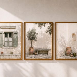 May include: A set of three framed wall art prints featuring Mediterranean architecture. The images display a window with sage green shutters, a stone bench with an olive tree in a terracotta pot, and a corner alcove with large clay vessels.