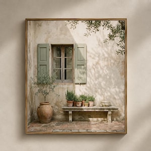 May include: A framed wall art print depicting a rustic stone building exterior with a window featuring sage green shutters. A large terracotta pot with a small tree sits on a brick patio next to a stone bench holding several potted green plants.