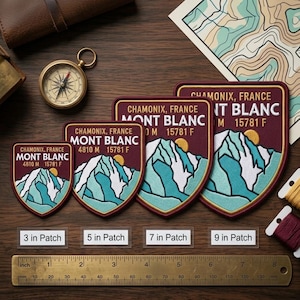 May include: Embroidered patches with the text "Chamonix, France Mont Blanc" and a mountain and sun design. Available in 7.6, 12.7, 17.8, and 22.9 cm sizes. The patches have a burgundy background with teal and white mountain details.