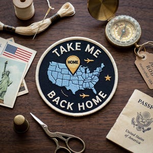 May include: A round, navy blue patch with the text "TAKE ME BACK HOME" encircling a light blue embroidered map of the United States. The patch includes a gold-colored pin and two small airplanes. Other items include a compass, passport, and sewing supplies.