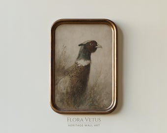 May include: A framed vintage print of a pheasant in a field. The artwork features a brown and white bird with a red face and a white neck, set against a muted background. The frame is a warm, antique gold colour. The text "FLORA VETUS HERITAGE WALL ART" is at the bottom.