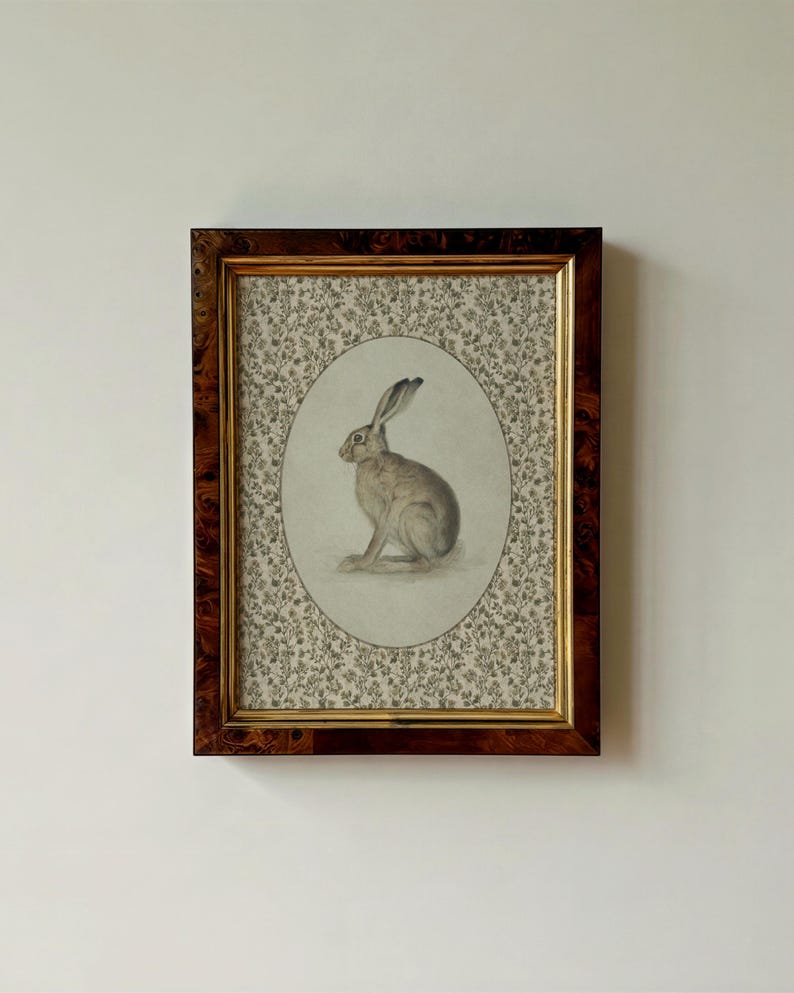 Hare portrait in a rectangular vintage frame on a neutral wall, emphasizing balanced composition.