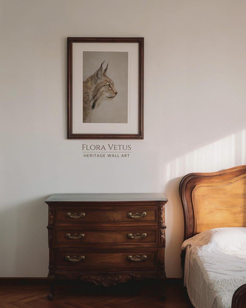 Bedroom mockup with the bobcat print hung above a wooden dresser, warm heritage styling.