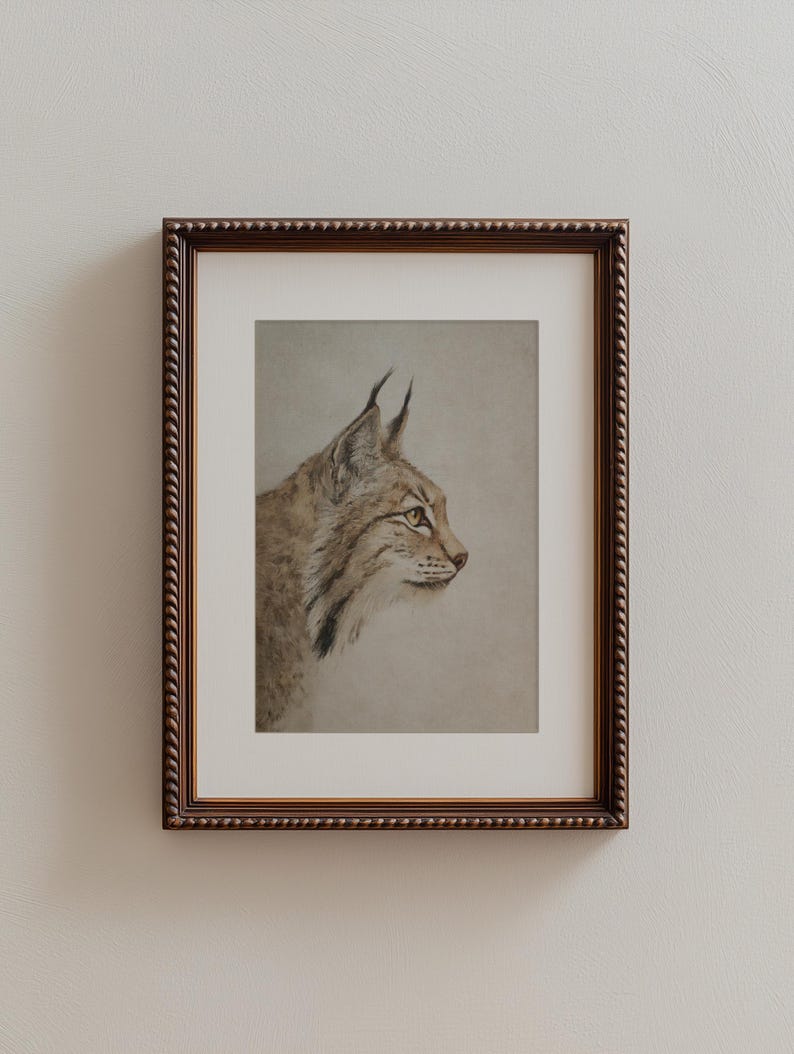 Vertical framed version with wide mat around the bobcat portrait, emphasizing generous negative space.