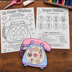Può includere: Un foglio di attività stampabile intitolato My Prayer Telephone con una pagina da colorare di un telefono e una pagina di bottoni da ritagliare. Un lavoretto di carta finito e colorato con cornetta rosa e base blu sopra i fogli.