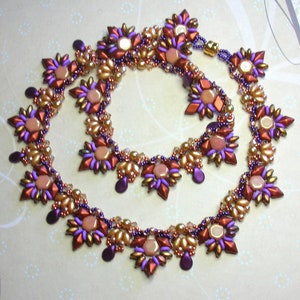 May include: A beaded necklace and matching choker set with a geometric starburst design. The beads are in shades of gold, purple, and orange.
