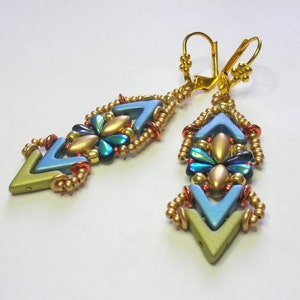 May include: A pair of gold and blue earrings with a geometric design. The earrings are made with small beads and have a chevron pattern.