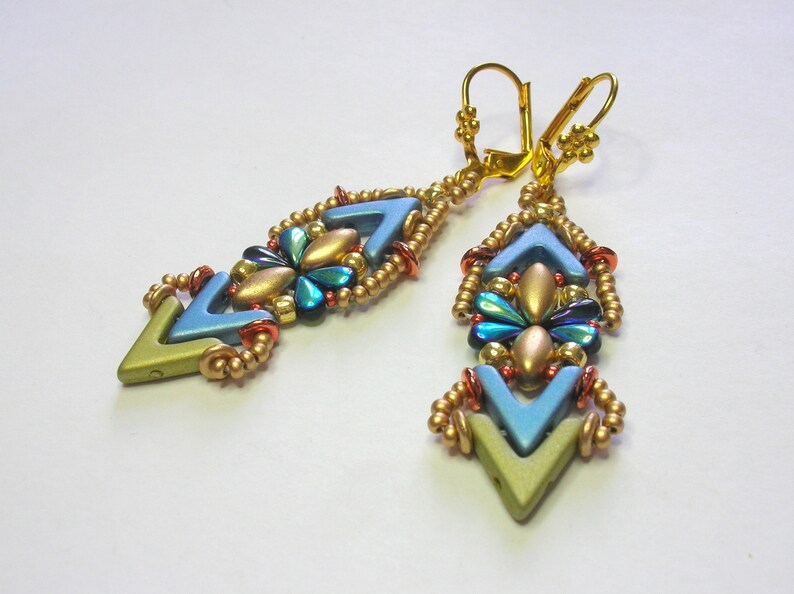 May include: A pair of gold and blue earrings with a geometric design. The earrings are made with small beads and have a chevron pattern.