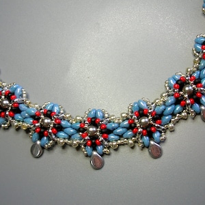 May include: A blue, red, and black beaded necklace with silver accents. The necklace is made of small, round beads and has a floral design.