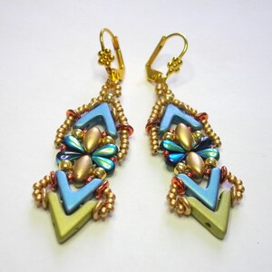 May include: A pair of gold dangle earrings with blue, green, and gold beads. The earrings are shaped like a diamond with a pointed bottom.