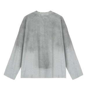 May include: A long-sleeve crew neck shirt in a light gray color featuring a subtle gradient effect that transitions to a darker gray tone toward the top. The garment displays a distressed aesthetic with small, scattered holes throughout the fabric.