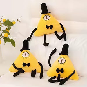 May include: Three yellow triangle plush toys with black top hats, bow ties, and one eye. The plush toys have black arms and legs. The toys are on a white surface.