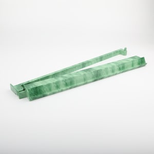 May include: A pair of jade green tongs, featuring a rectangular design with a marbled texture. The tongs are open, displaying their full length and the intricate veining of the stone. The background is plain white.