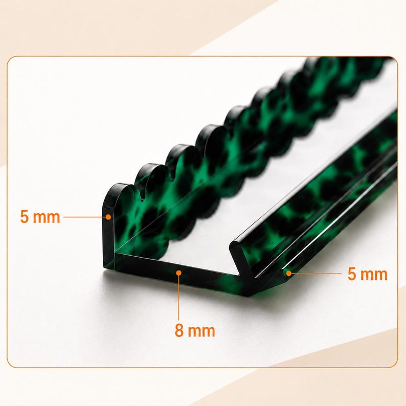 May include: A clear, green, and black acrylic desk organiser with a scalloped edge. The organiser is L-shaped, with dimensions of 5 mm thick and 8 mm wide. The green and black pattern is visible throughout the acrylic.