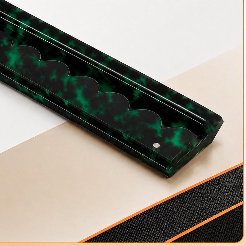 May include: A rectangular, dark green tray with a scalloped edge design. The tray has a mottled pattern of green and black, with a small circular indentation. The tray is angled against a white and beige background.