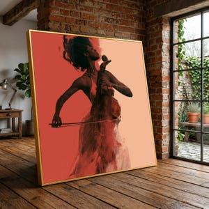 May include: A square framed wall art piece featuring a stylised illustration of a person playing a cello. The artwork uses a colour palette of deep red, coral, and soft peach tones, with a dark silhouette of the musician and instrument.