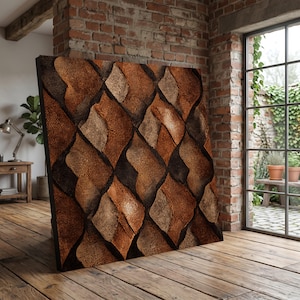 May include: A large, square wall art piece with a textured, geometric pattern. The design features overlapping, organic shapes in shades of brown, tan, and black, creating a layered effect. The artwork is displayed in a room with a brick wall and wooden floor.