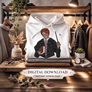 May include: White hoodie with a graphic of a character holding a wand and book, with text within the illustration. The hoodie is displayed on a wooden surface with other clothing and accessories. The image includes the text "DIGITAL DOWNLOAD" and "INSTANT DOWNLOAD".