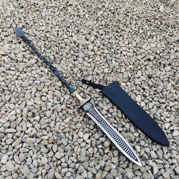 A real blacksmith hand-forged a Damascus steel spear with a leather sheath — the kind of wall-worthy, conversation-starting piece you genuinely can't find at a mall.