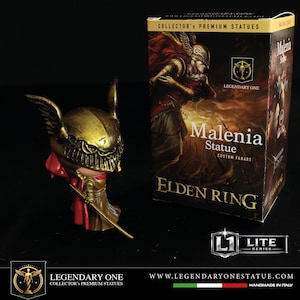 May include: A gold Malenia statue from Elden Ring, with a red cape and a sword. The statue is next to a box with the text "Malenia Statue" and "Elden Ring". The box also says "Collector's Premium Statues".