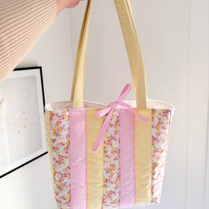 May include: A set of three ceramic mugs with a speckled, matte finish. The mugs are in shades of cream, light gray, and dark gray. Each mug has a simple, minimalist design, perfect for coffee or tea.