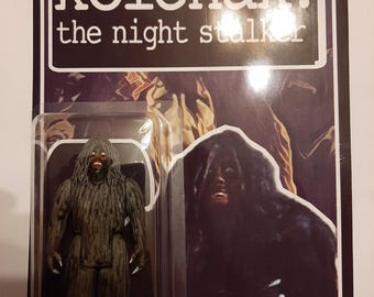 May include: A vintage-style action figure of a Rakshasa monster from the "Kolchak: The Night Stalker" series. The figure is in a clear plastic case, with the show's logo and the name "Rakshasa" printed on the packaging.