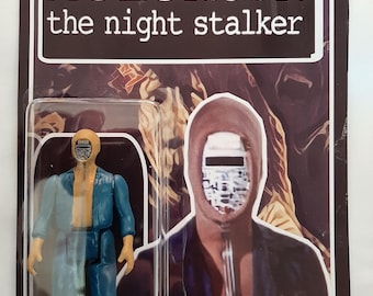 May include: A vintage-style action figure of "Kolchak: The Night Stalker" in a clear plastic case. The figure is wearing a blue and tan jumpsuit. The packaging features the show's title and an illustration of a character.