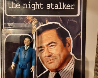 May include: A vintage action figure of Kolchak: The Night Stalker, featuring a figure in a blue suit. The packaging includes the show's title and an image of Tony Vincenzo. The figure is in a clear plastic case.