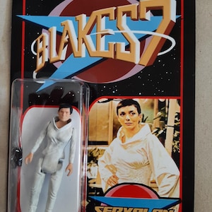 May include: A vintage action figure of Servalan from the sci-fi series Blake's 7. The figure is in a clear plastic case on a retro-style card with the show's logo and a photo of the character. The card has a black background with red and blue accents.