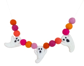 May include: A Halloween garland with white felt ghosts and orange, pink, and purple felt balls strung on a white string.