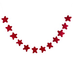 May include: A red felt star garland with 12 stars hanging on a white string.