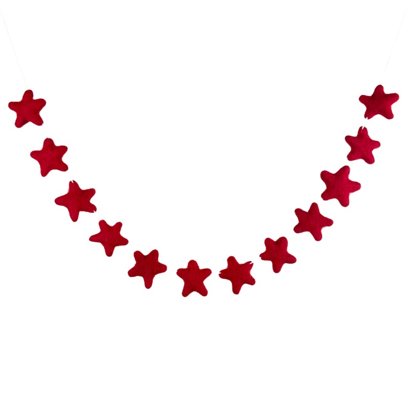 May include: A red felt star garland with 12 stars hanging on a white string.
