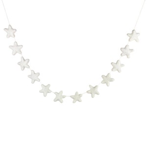 May include: A white felt star garland with 12 stars strung on a white string.