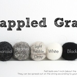 May include: Five felt balls in various shades of gray, white, and black. The balls are labeled "Charcoal", "Heather Gray", "Light Pebble Gray", "White", and "Black". The text "Dappled Gray" is at the top of the image. Felt balls are 1 inch (about the size of a quarter).