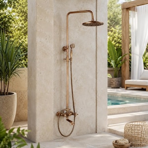 May include: A wall-mounted shower system in a brushed bronze finish featuring a large circular overhead rainfall showerhead, a handheld shower wand with a flexible hose, and a lower faucet spout with two cross-style handles for water control.