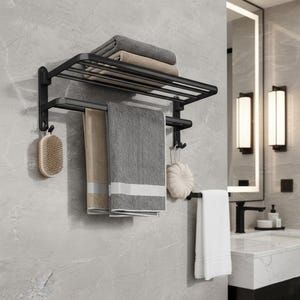 May include: A black metal towel rack mounted on a gray tiled wall. The rack holds folded gray and beige towels, plus hanging gray and beige towels. A white towel hangs on a separate bar. A wooden brush and a white sponge are also hanging.
