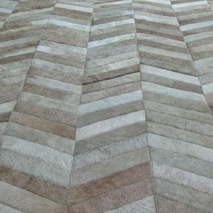 Beige Cowhide Rug: Chevron Patchwork Design, Handmade