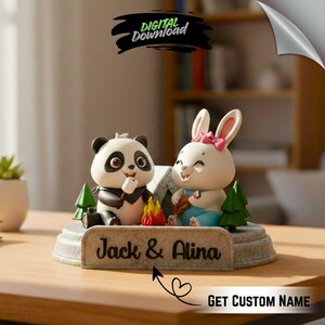 May include: A decorative figurine featuring a panda and a rabbit camping. The panda is black and white, and the rabbit is white with a pink bow. A sign reads "Jack & Alina". The figurine includes a campfire and small green trees.