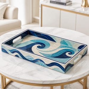May include: A rectangular serving tray featuring a mosaic pattern of swirling ocean waves in shades of deep blue, light blue, and cream. The tray has a smooth finish, a raised border, and two integrated cutout handles on the shorter sides.