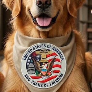 May include: A Golden Retriever dog wearing a tan bandana with a patriotic emblem. The emblem features the text "UNITED STATES OF AMERICA" and "250 YEARS OF FREEDOM" with an eagle and American flag design.
