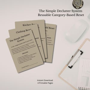 May include: A set of four printable pages with decluttering system instructions. The pages are beige with black text, including the title "The Simple Declutter System." The image also includes a white computer mouse, a clipboard, and a small succulent.