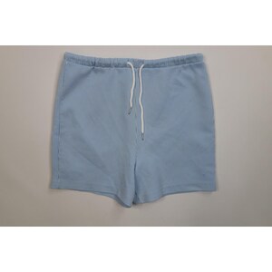 May include: Light blue and white striped shorts with a drawstring waist. The shorts are made of a soft fabric and have a relaxed fit. The shorts are perfect for warm weather and casual wear.