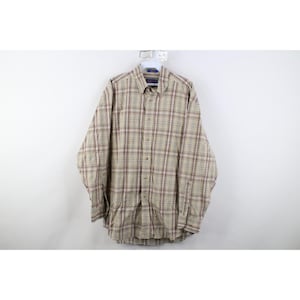 May include: A white ceramic mug with a black handle and the text "But First, Coffee" in a bold, black font. The mug is sitting on a wooden surface. The mug is approximately 4 inches tall.