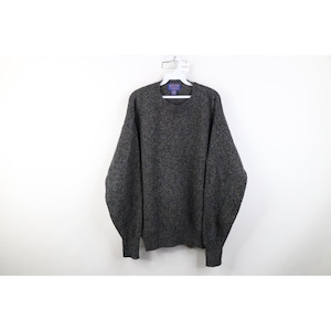 May include: A dark gray sweater with a crew neck and long sleeves hangs on a white hanger. The sweater has a speckled texture and ribbed cuffs and hem. The garment is made of a thick, warm material, perfect for cold weather.